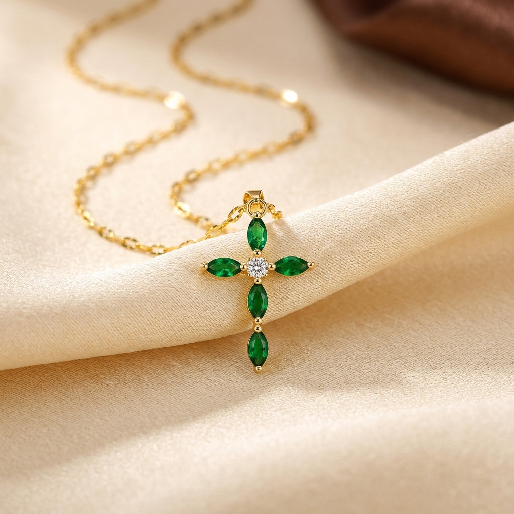 Colar dourado Rose & Oliver com pingente de cruz marquise decorada com esmeraldas verdes brilhantes.